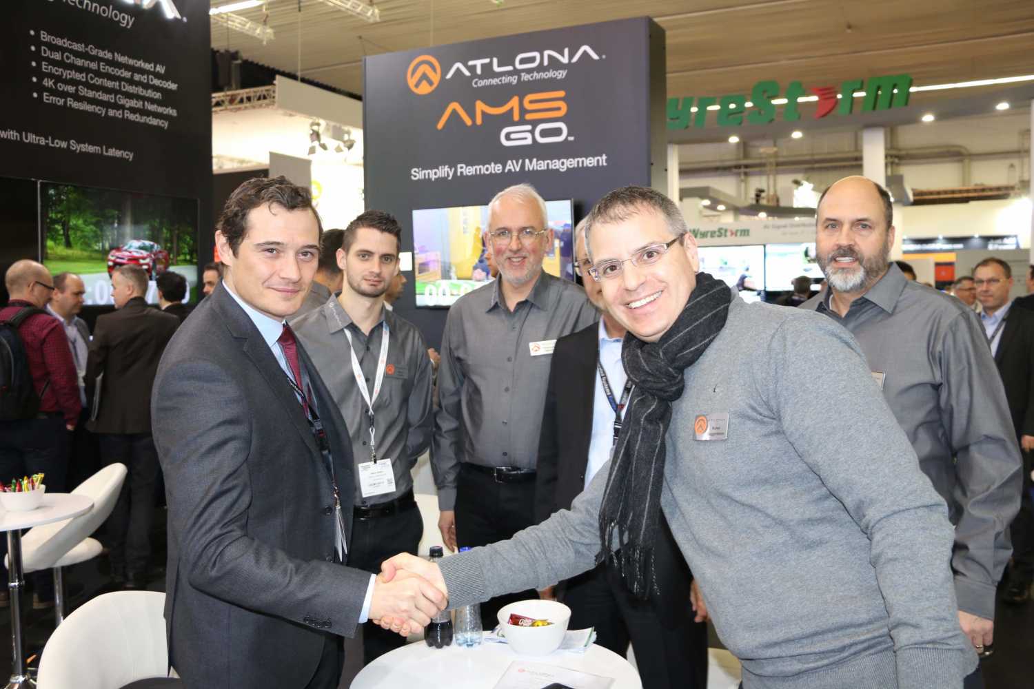 Sidev managing director Mathieu Payet and Atlona general manager Ronni Guggenheim shake hands at the official signing during ISE 2017 in Amsterdam