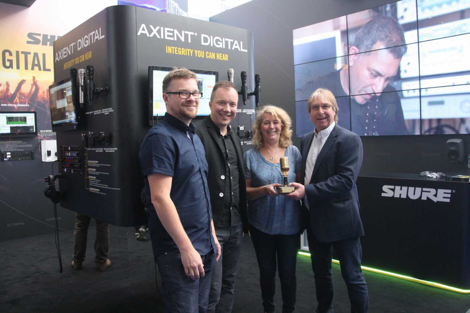 Stuart Moots and Tuomo Tolonen of Shure UK at the PLASA Show presenting Heather and John Penn of SSE with the Rental Partner of the Year Award 2017