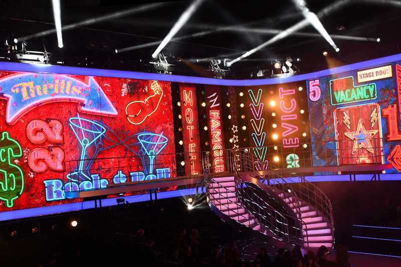 The evictions take place against a grand curved video wall
