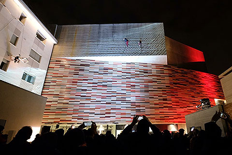 The vertical dance show took place across the ceramic-tiled façade of the building.