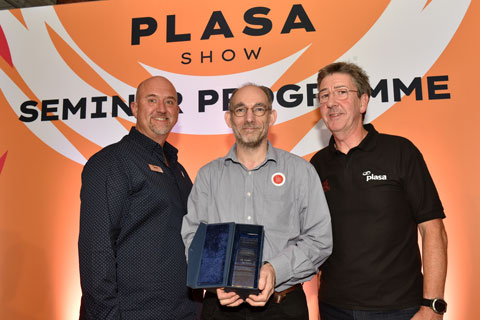 JB Toby (centre) receives his Gottelier Award trophy from PLASA chair, Adam Blaxill (left) and PLASA MD, Peter Heath (right)